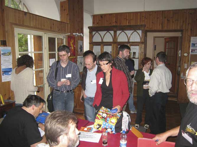 The registration desk, François Colas and Greg Sinitsin at the desk, Jiri Borovicka, Pavel Koten, Dragana Okolic in front and Jürgen Rendtel at right. In the background Frans Lowiessen, Galina Ryabova and Detlef Koschny in discussion (credit Casper ter Kuile).