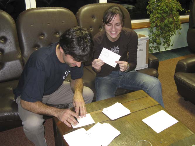 Juraj Toth and Regina Rudawska signing the IMC postcards to be sent to missing friends (credit Xiang Zhan).
